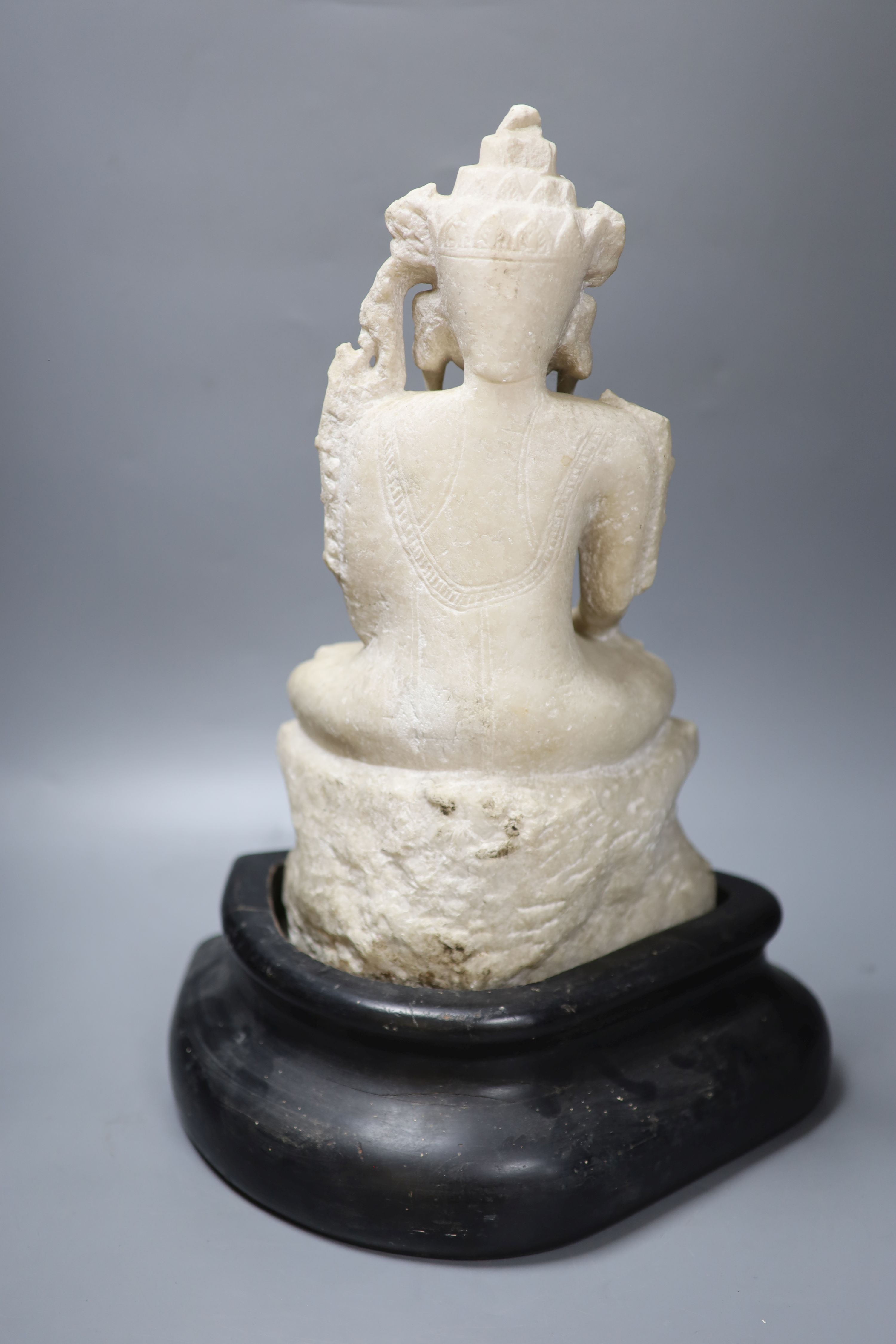 A 19th century Burmese marble crowned Jambhupati Buddha, on stand, overall height 47cm